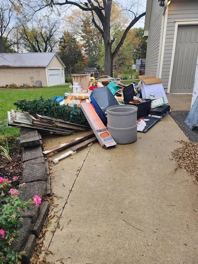 Dumpster being loaded with debris for Roofing Dumpster Rental in Barbecue